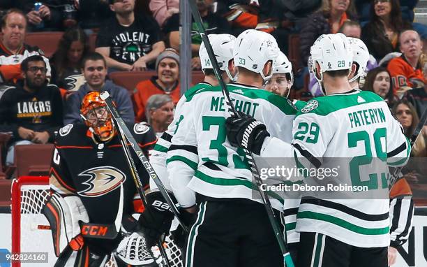 Dallas Stars players celebrate a first-period goal by Marc Methot as goalie Ryan Miller of the Anaheim Ducks reacts during the game at Honda Center...