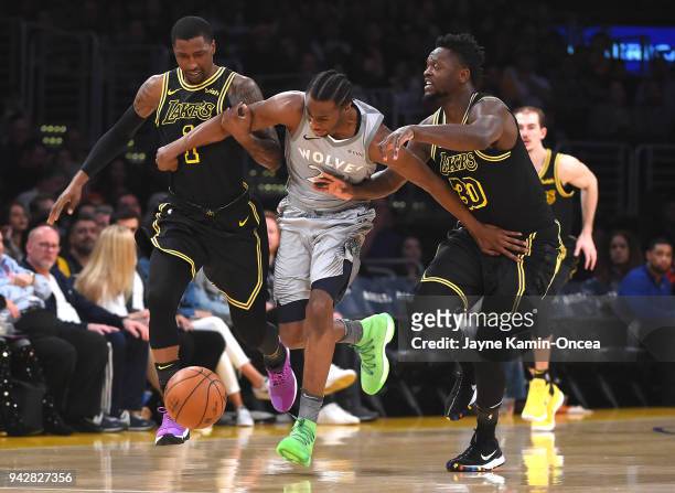 Andrew Wiggins of the Minnesota Timberwolves beats Kentavious Caldwell-Pope and Julius Randle of the Los Angeles Lakers to a loose ball and runs it...