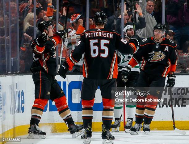 Josh Manson, Marcus Pettersson and Corey Perry of the Anaheim Ducks celebrate Manson's second-period goal during the game against the Dallas Stars at...