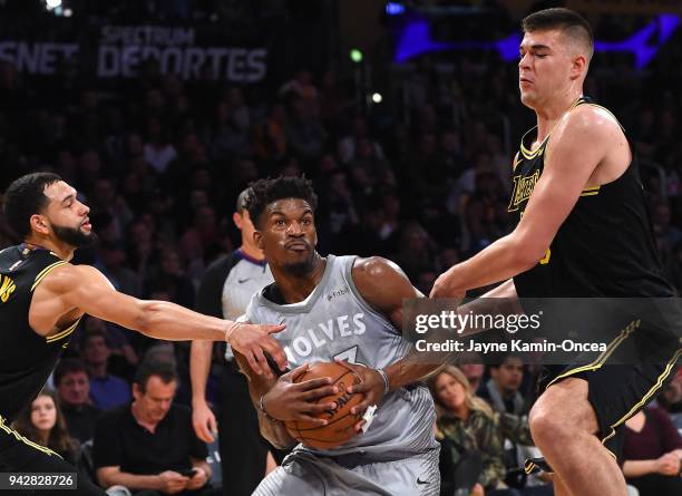 Jimmy Butler of the Minnesota Timberwolves gets past Tyler Ennis as he is fouled by Ivica Zubac of the Los Angeles Lakers as he drives to the basket...