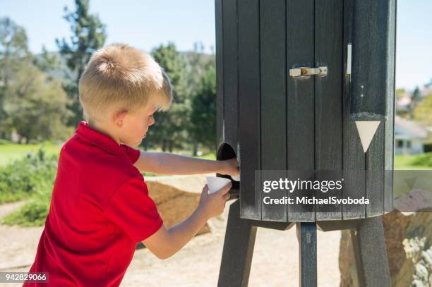 junior golfer getting water - amateur golfer stock pictures, royalty-free photos & images