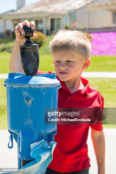junior golfer cleaning his golf ball - amateur golfer stock pictures, royalty-free photos & images