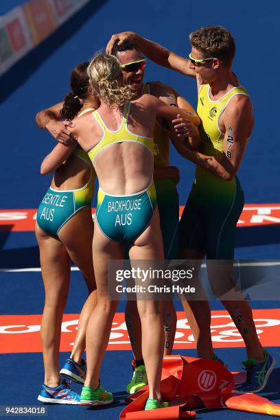 Jacob Birtwhistle of Australia celebrates with team mates Matthew Hauser, Gillian Backhouse and Ashleigh Gentle after winning Gold in the Triathlon...