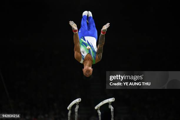 Cyprus' Marios Georgiou competes on the parallel bars during the men's individual all-around final in the artistic gymnastics event during the 2018...