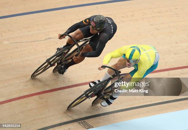 Muhammad Shah Firdaus Sahrom of Malaysia knocks out Matt Glaetzer of Australia in the Men's Sprint 1/8 Finals during Cycling on day three of the Gold...