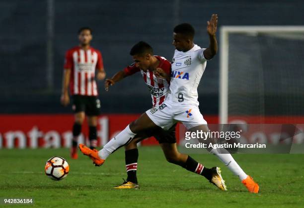 Alison of Santos of Santos fights for the ball with Ivan Gomez of Estudiantes during a match between Estudiantes and Santos as part of Copa CONMEBOL...