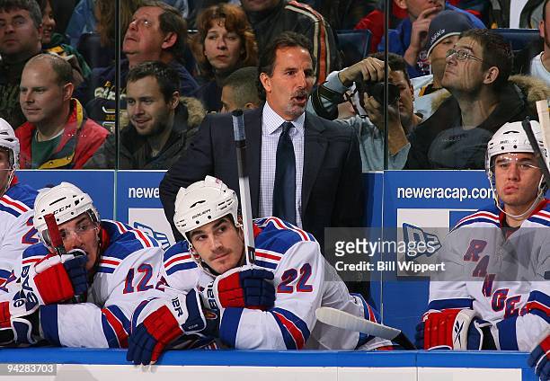 Head coach John Tortorella and Brian Boyle of the New York Rangers watch the play against the Buffalo Sabres on December 5, 2009 at HSBC Arena in...