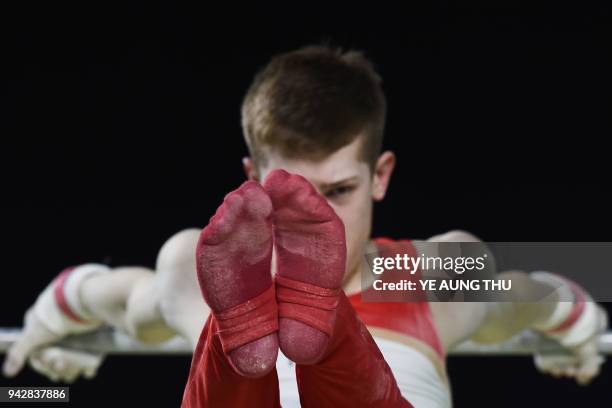 Jersey's Daniel Lee competes on the bar during the men's individual all-around final in the artistic gymnastics event during the 2018 Gold Coast...