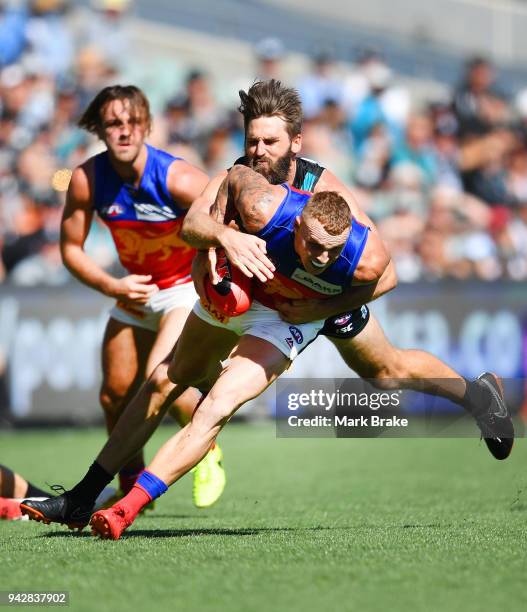 Justin Westhoff of Port Adelaide catches Mitch Robinson of the Lions during the round three AFL match between the Port Adelaide Power and the...
