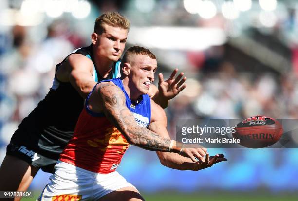 Mitch Robinson of the Lions handballs during the round three AFL match between the Port Adelaide Power and the Brisbane Lions at Adelaide Oval on...