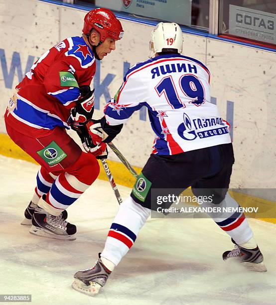 Famous Soviet, former NHL Detroit Red Wings' defender Viacheslav Fetisov of CSKA fights for the puck with Alexey Yashin of SKA St Petersburg during...