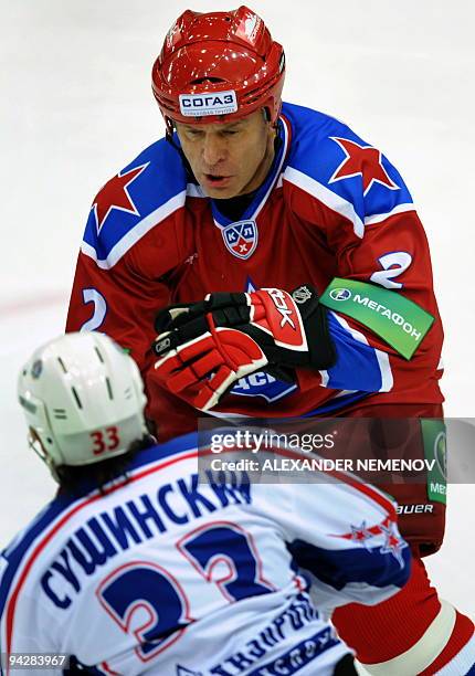 Veteran Russian player, former NHL Detroit Red Wings' defender Viacheslav Fetisov of CSKA fights for the puck with Maxim Sushinsky of SKA...