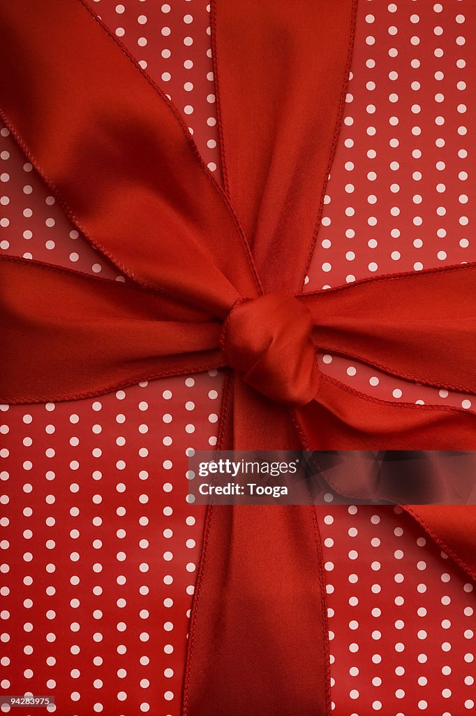 Red present with white polka dots and red ribbon