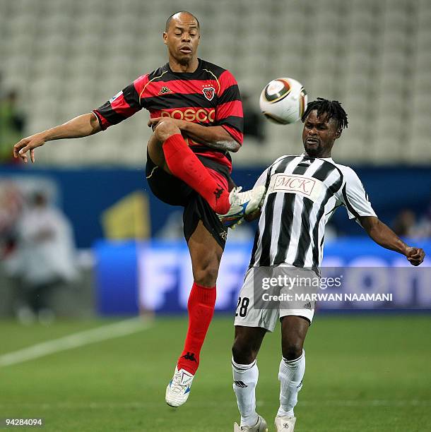 South Korean Pohang Steelers' Denilson Martins Nascimento challenges Congolese TP Mazembe's Kanyimbo Tshizeu during their 2009 FIFA Club World Cup...