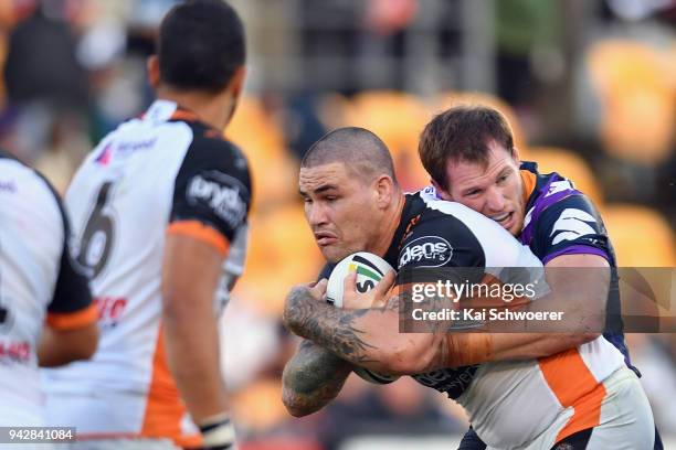 Russell Packer of the Tigers is tackled during the round five NRL match between the Wests Tigers and the Melbourne Storm at Mt Smart Stadium on April...