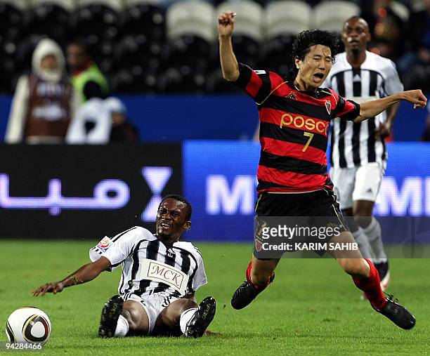 Congolese TP Mazembe's Mulota Kabangu falls as he fouls South Korean Pohang Steelers' Kim Jae-Sung during their 2009 FIFA Club World Cup...