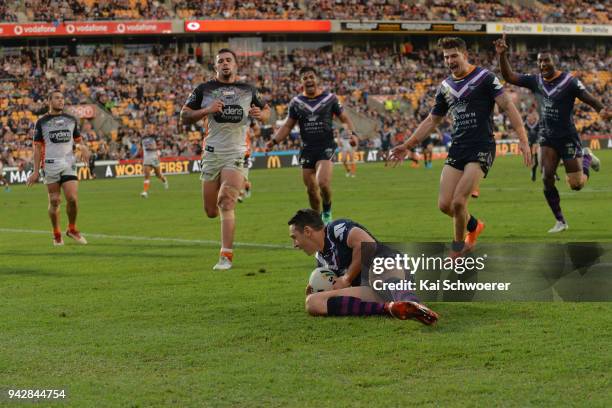 Billy Slater of the Storm dives over to score a try during the round five NRL match between the Wests Tigers and the Melbourne Storm at Mt Smart...