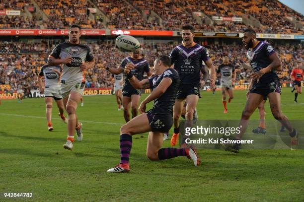 Billy Slater of the Storm celebrates scoring a try during the round five NRL match between the Wests Tigers and the Melbourne Storm at Mt Smart...
