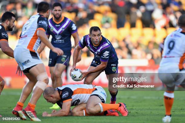 Cameron Smith of the Storm looks to pass the ball during the round five NRL match between the Wests Tigers and the Melbourne Storm at Mt Smart...