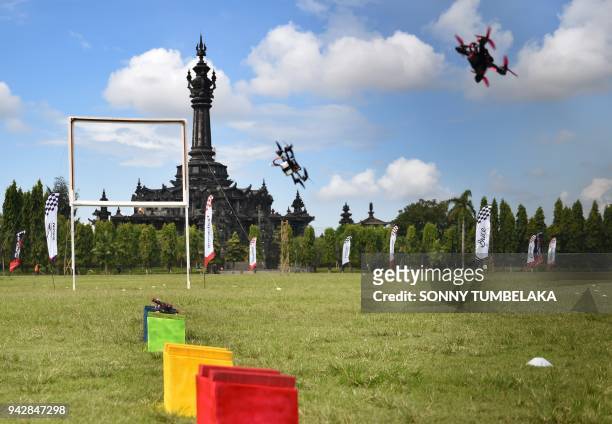 Race drones flies in front of the Bajra Sandhi monument during the FAI Drone Racing World Cup event in Denpasar on Indonesia's resort island of Bali...