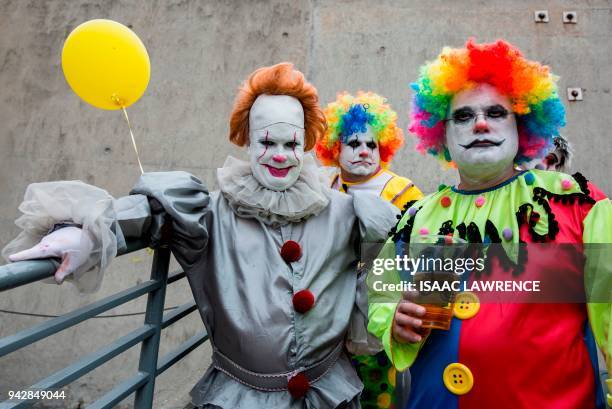 Fans dressed up in costumes attend the rugby tournament of the Hong Kong Sevens at Hong Kong Stadium on the second day on April 7, 2018. / AFP PHOTO...