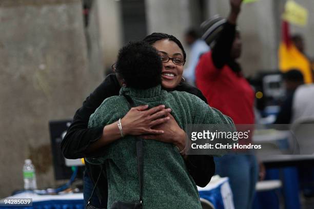 Mortgage counselor Latonya Patterson of Charlotte, North Carolina with the Neighborhood Assistance Corporation of America hugs a home owner she just...