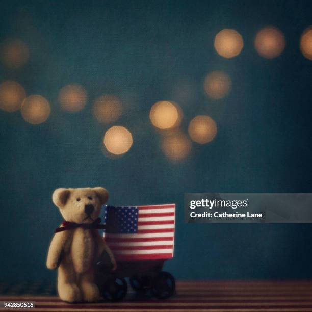 patriotic bear with string lights and american flag - american flag texture stock-fotos und bilder