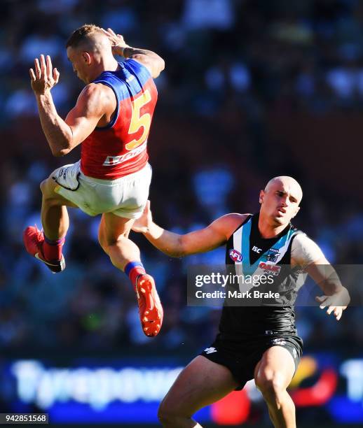 Mitch Robinson of the Lions and Sam Powell-Pepper of Port Adelaide collide during the round three AFL match between the Port Adelaide Power and the...