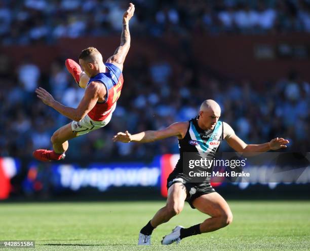 Mitch Robinson of the Lions and Sam Powell-Pepper of Port Adelaide collide during the round three AFL match between the Port Adelaide Power and the...