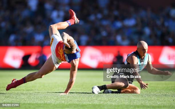 Mitch Robinson of the Lions and Sam Powell-Pepper of Port Adelaide collide during the round three AFL match between the Port Adelaide Power and the...