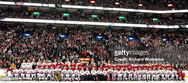 Former Montreal Canadiens players and current player sit for the official team photo during the Centennial Celebration ceremonies prior to the NHL...