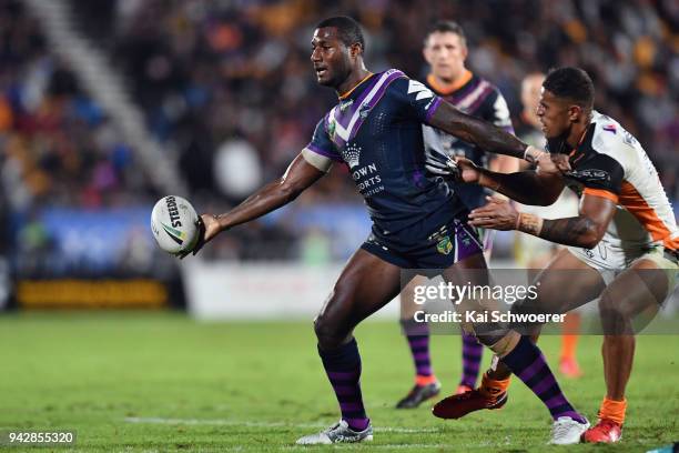 Suliasi Vunivalu of the Storm offloads the ball during the round five NRL match between the Wests Tigers and the Melbourne Storm at Mt Smart Stadium...