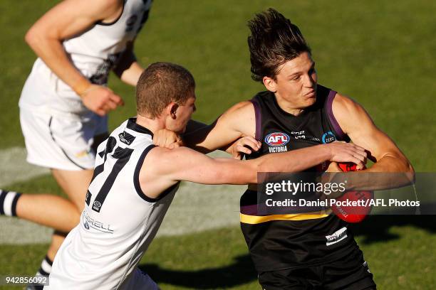 Laitham Vandermeer of the Bushrangers is tackled by Noah Young of the Falcons during the round three TAC Cup match between Murray Bushrangers and...