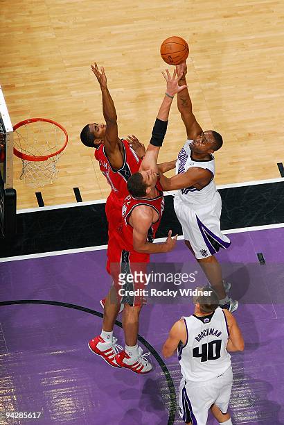 Kenny Thomas of the Sacramento Kings hooks a shot over Sean Williams and Brook Lopez of the New Jersey Nets during the game on November 27, 2009 at...