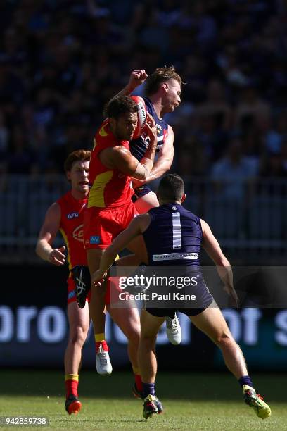 Jarrod Harbrow of the Suns sets for a mark against Cam McCarthy of the Dockers during the round three AFL match between the Gold Coast Suns and the...