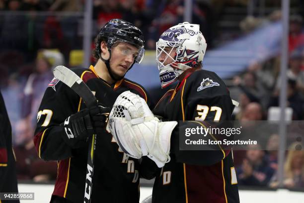 Cleveland Monsters goalie Jeff Zatkoff is congratulated by Cleveland Monsters center Calvin Thurkauf following American Hockey League game between...