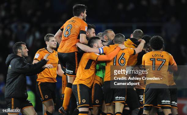 Wolverhampton Wanderers players and staff mob Wolverhampton Wanderers' John Ruddy after Cardiff City second injury time penalty during the Sky Bet...