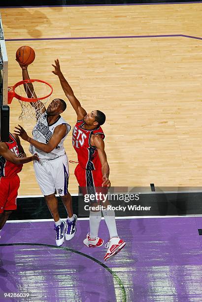 Kenny Thomas of the Sacramento Kings lays up a shot against Sean Williams of the New Jersey Nets during the game on November 27, 2009 at Arco Arena...