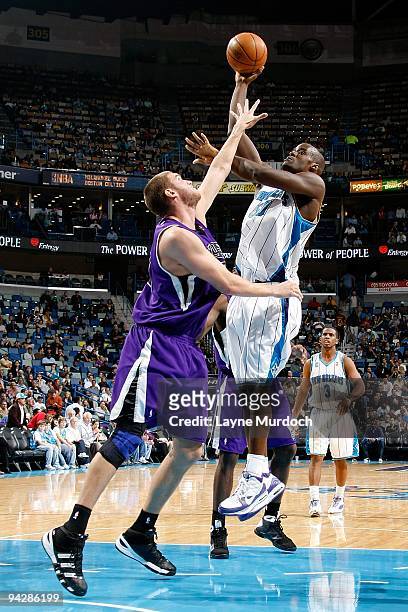 Emeka Okafor of the New Orleans Hornets puts up a shot under pressure against Spencer Hawes of the Sacramento Kings during the game on December 8,...