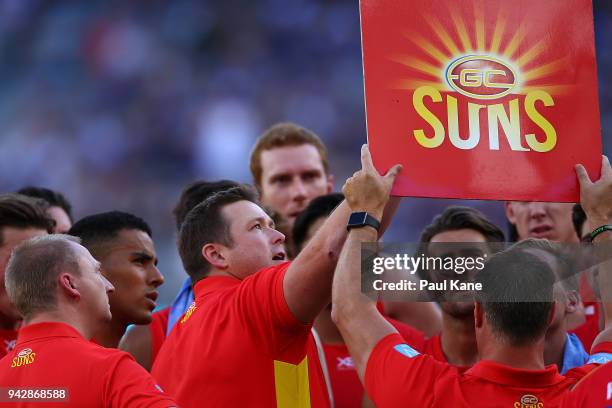 Stuart Dew, coach of the Suns addresses his players at the quarter time break during the round three AFL match between the Gold Coast Suns and the...