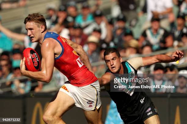 Harris Andrews of the Lions is tackled by Tom Rockliff of the Power during the 2018 AFL round 03 match between the Port Adelaide Power and the...