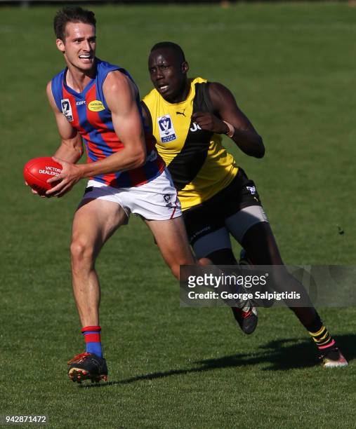 Lucas Cook of Port Melbourne runs away from Mabior Chol of Richmond during the round one VFL match between Port Melbourne and Richmond on April 7,...