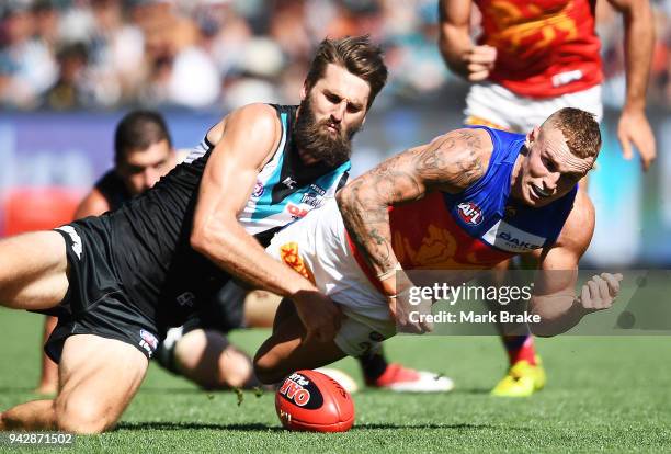 Justin Westhoff of Port Adelaide catches Mitch Robinson of the Lions during the round three AFL match between the Port Adelaide Power and the...