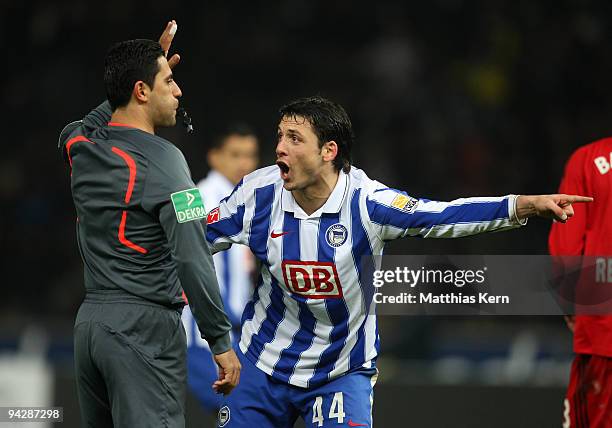 Gojko Kacar of Berlin discusses with referee Babak Rafati during the Bundesliga match between Hertha BSC Berlin and Bayer 04 Leverkusen at Olympic...