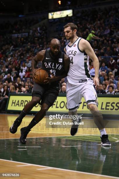 Quincy Acy of the Brooklyn Nets dribbles the ball while being guarded by Tyler Zeller of the Milwaukee Bucks in the second quarter at the Bradley...