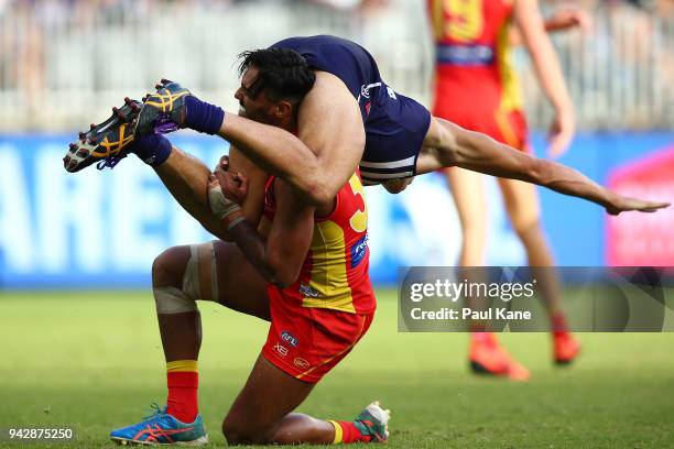 Aaron Hall of the Suns and Bailey Banfield of the Dockers wrestle during the round three AFL match between the Gold Coast Suns and the Fremantle...