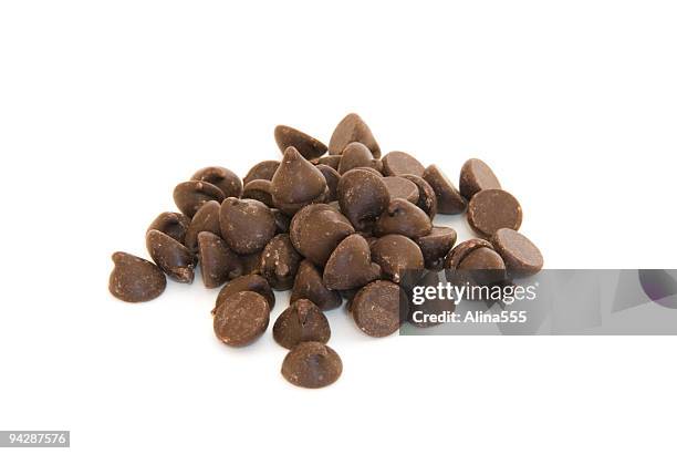 pile of chocolate chips on white - chocolate chip stock pictures, royalty-free photos & images