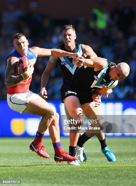 Mitch Robinson of the Lions shrugs off Sam Powell-Pepper of Port Adelaide during the round three AFL match between the Port Adelaide Power and the...