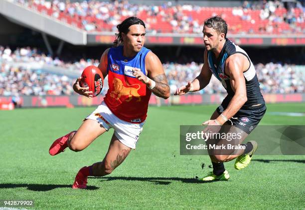 Allen Christensen of the Lions under pressure from Travis Boak captain of Port Adelaide during the round three AFL match between the Port Adelaide...