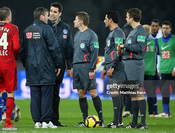 Head coach Friedhelm Funkel, manager Michael Preetz and referee Babak Rafati discuss after the Bundesliga match between Hertha BSC Berlin and Bayer...